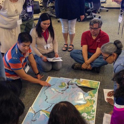 Participants in the Southwest Native Science Educators Workshop (NSEW) piece together a cut-out map of tectonic plates around the world.